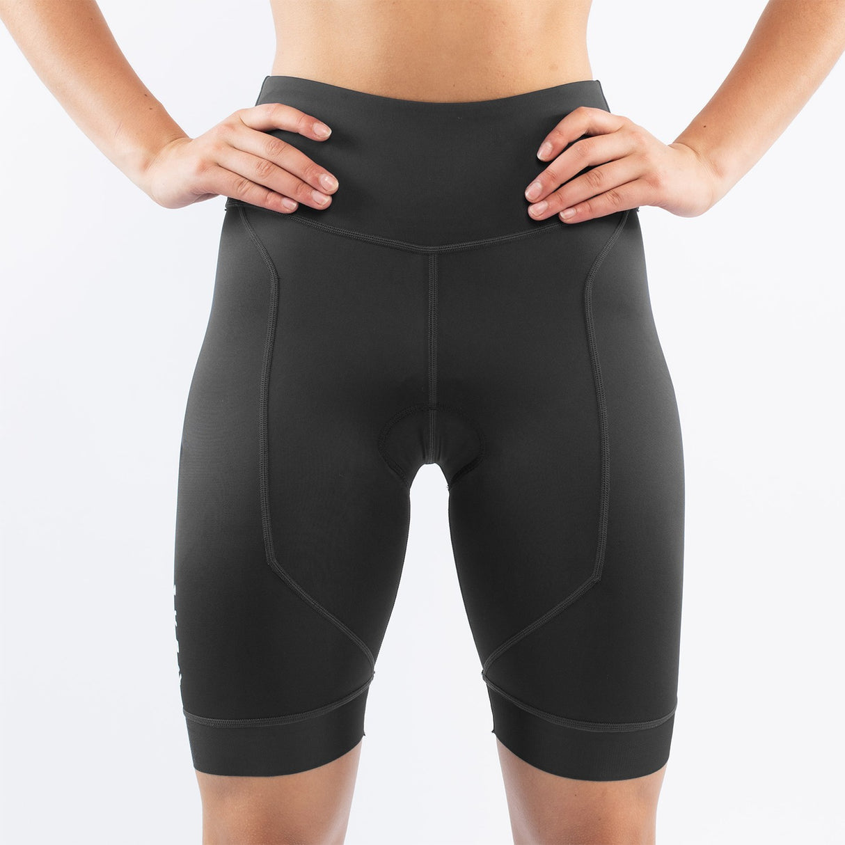Black athletic triathlon shorts worn by a woman on a white background