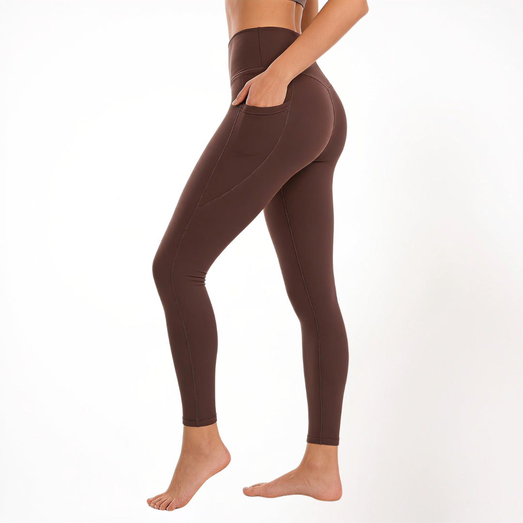 Brown athletic yoga gym leggings worn by a person on a white background
