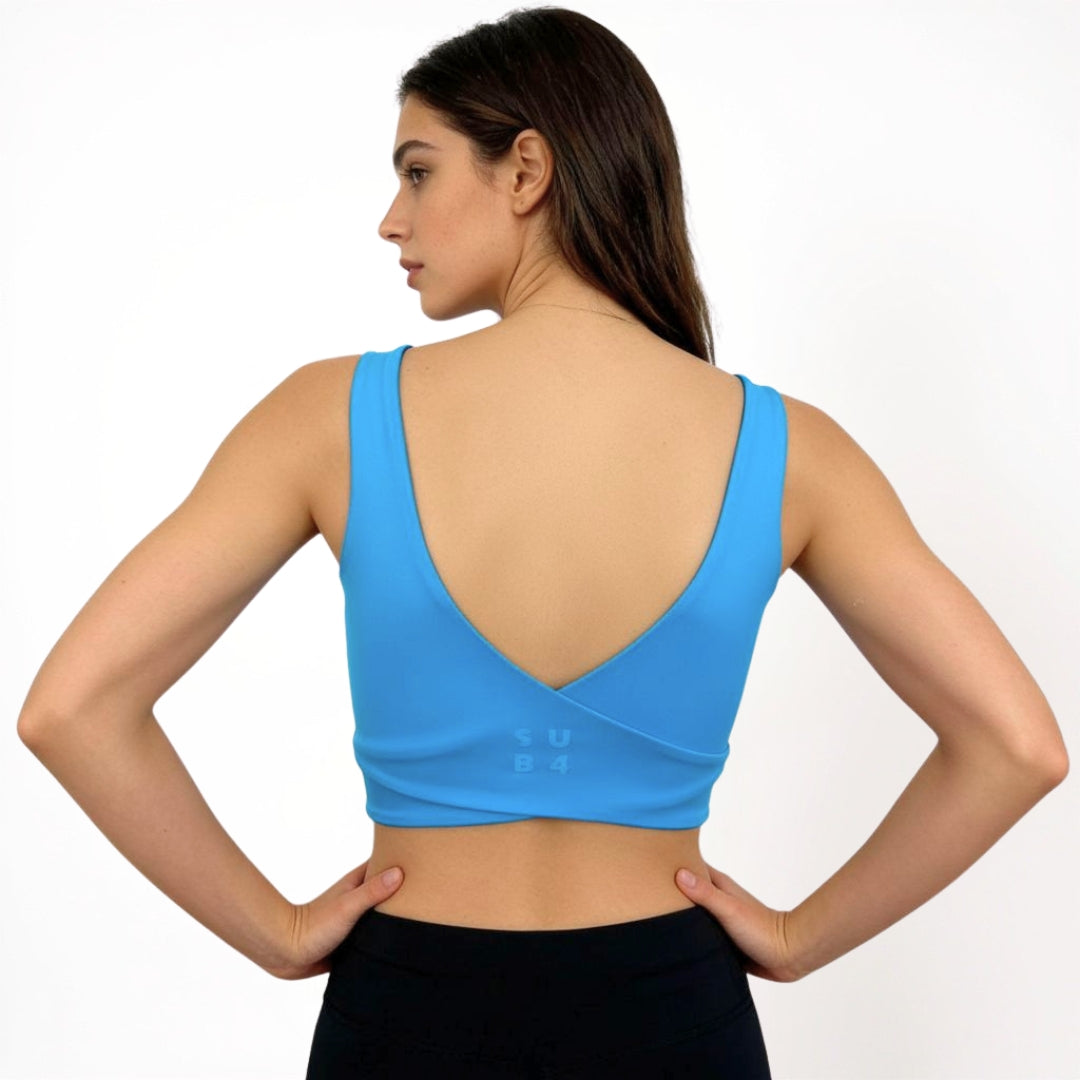 Woman wearing a blue sports bra on a white background