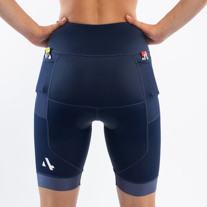 Navy blue athletic triathlon shorts worn by a person on a white background