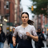Woman running on a city street with blurred background