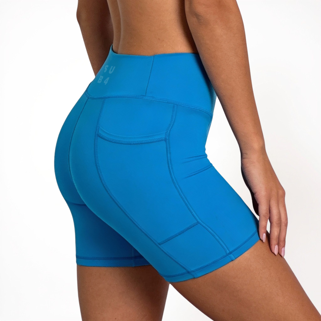 Blue athletic shorts worn by a person on a white background