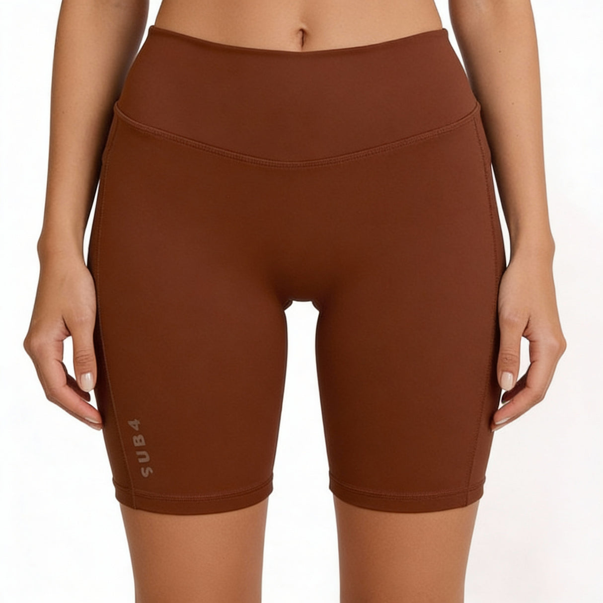 Brown athletic shorts worn by a person on a white background