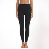 Black athletic yoga gym leggings worn by a person on a white background