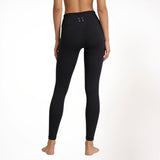 Black athletic gym yoga leggings worn by a person on a white background