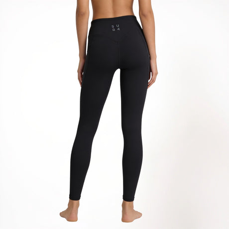 Black athletic gym yoga leggings worn by a person on a white background