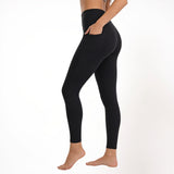 Black athletic yoga gym leggings worn by a person on a white background