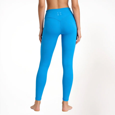 Blue athletic yoga gym leggings worn by a person on a white background
