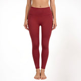 Red athletic yoga gym leggings worn by a person on a white background
