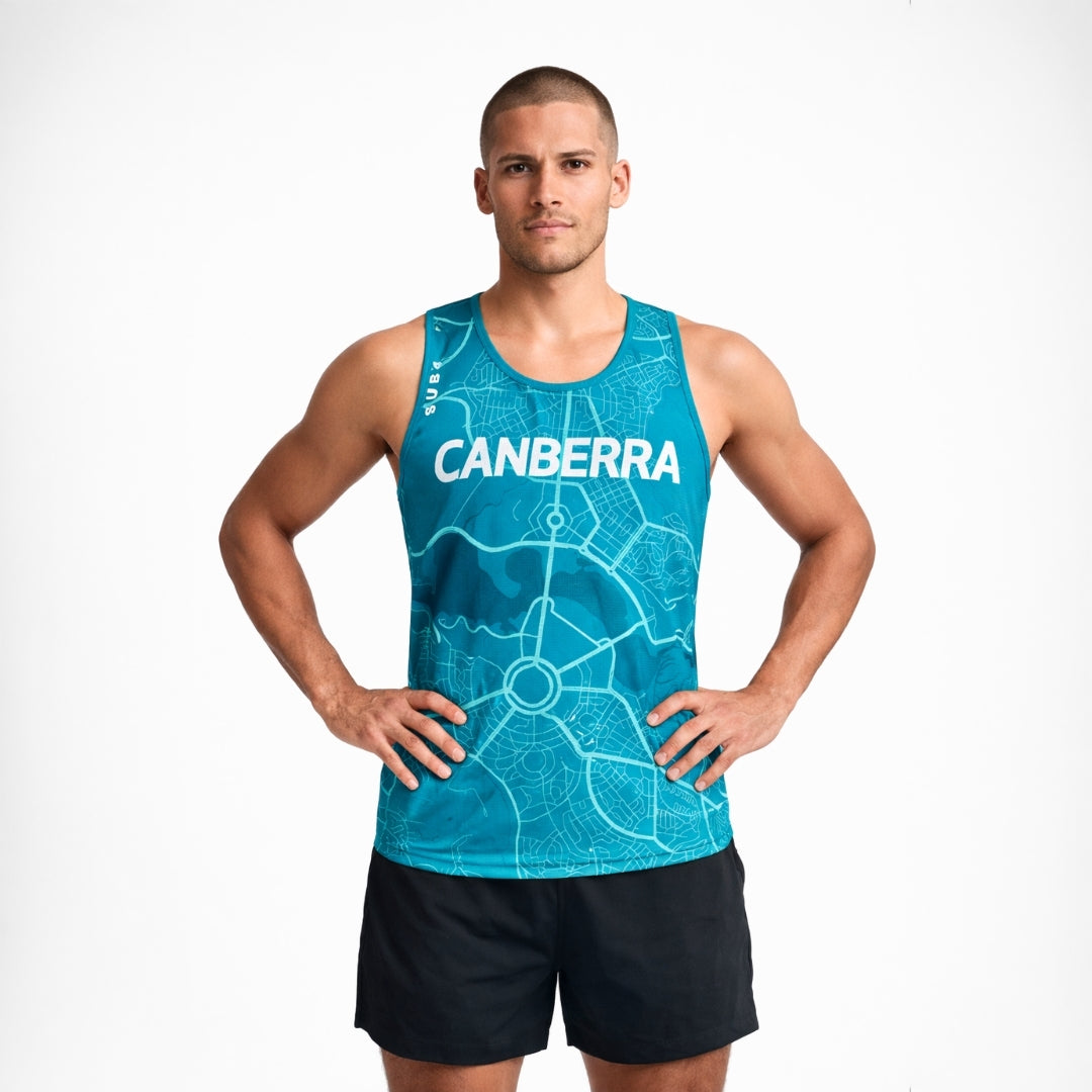 Man wearing a blue tank top with 'Canberra' printed on it against a white background