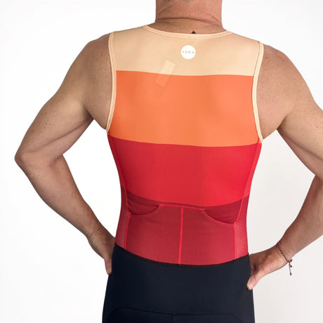 Person wearing a red and orange athletic vest on a white background